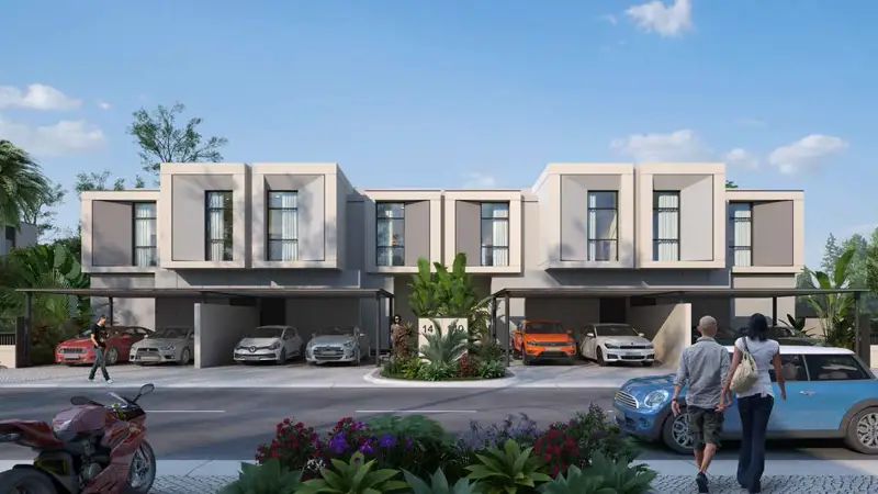 Group of three people smiling in front of gray brick wall, cropped in a hexagonal shape with rounded corners